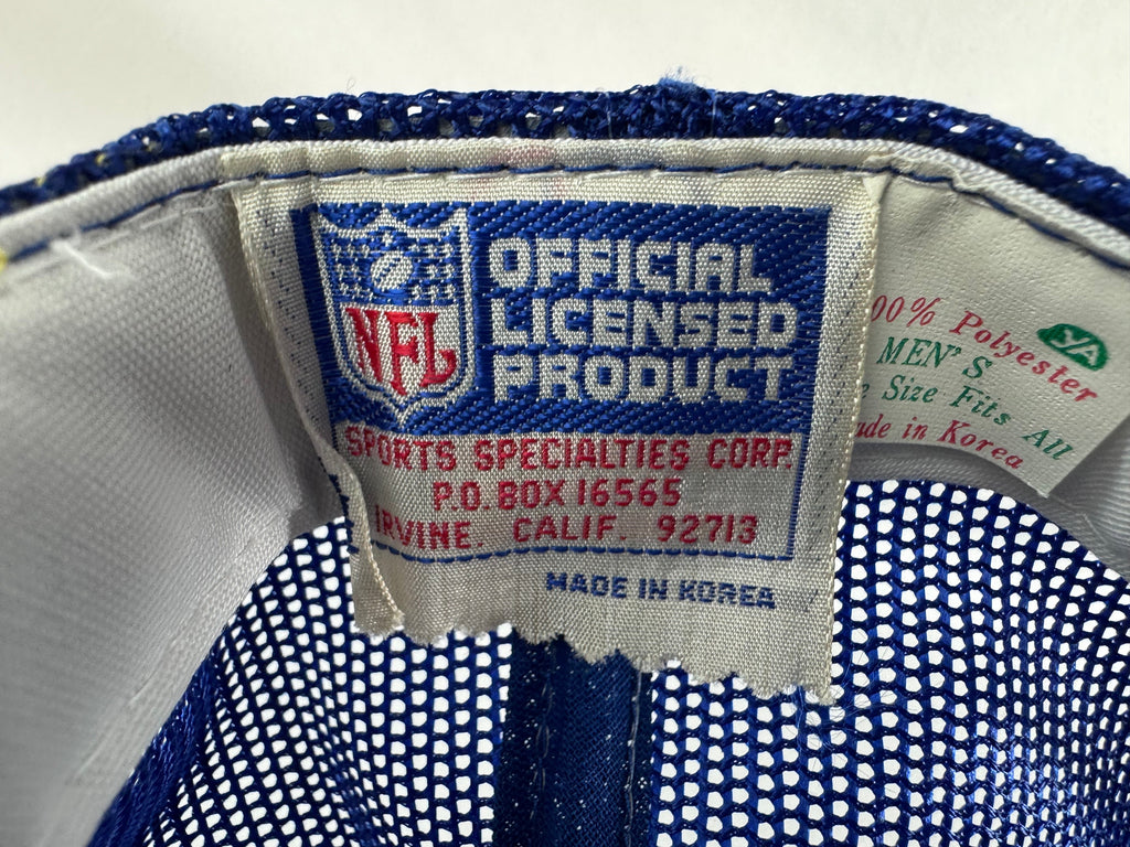 Close-up of the interior label of a blue and white mesh cap, showing the NFL logo and text reading 'Official Licensed Product' and 'Sports Specialties Corp.'.