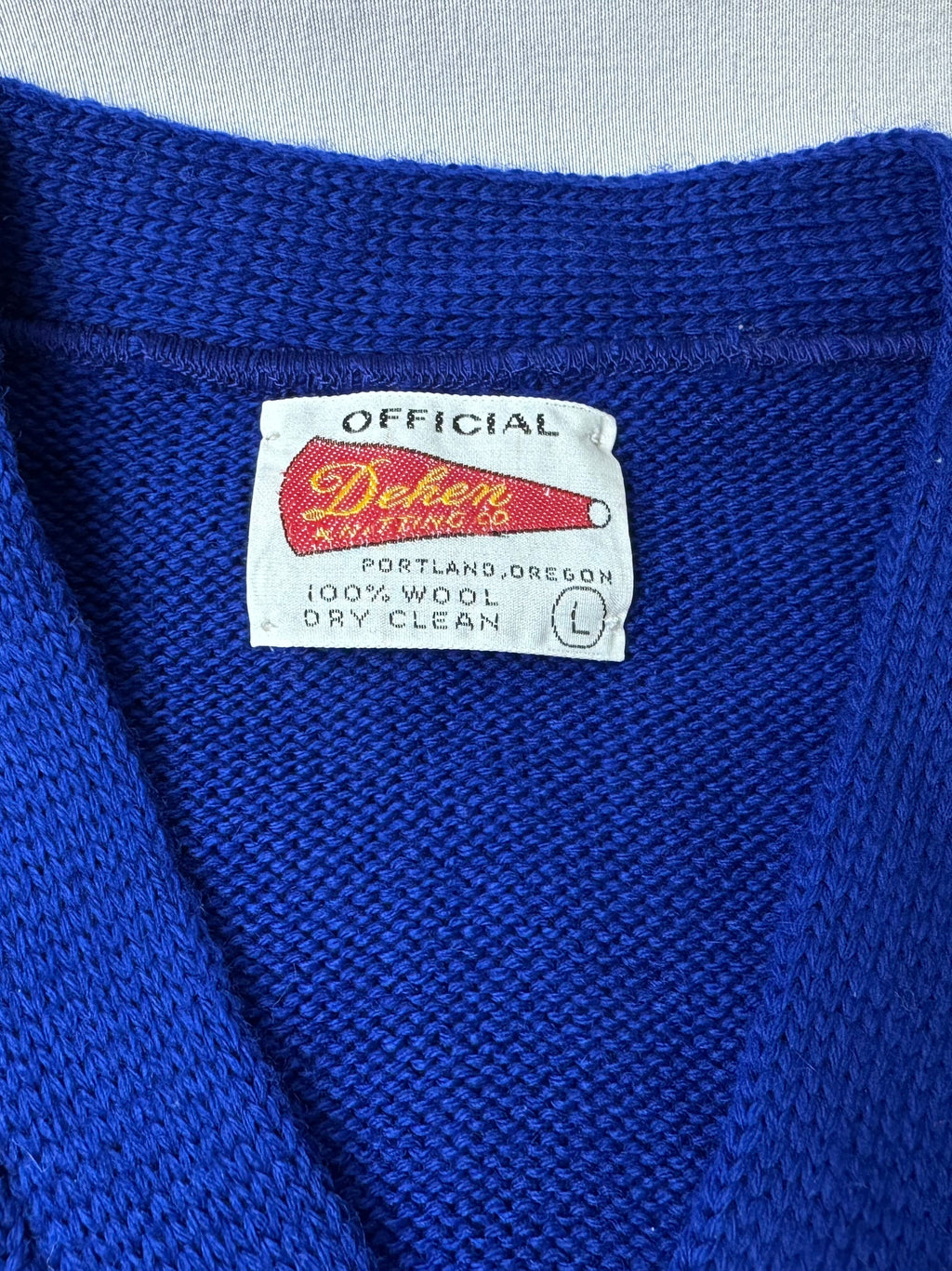 Up close tag shot saying Official Dehen Knitting. Portland, Oregon, 100% Wool, Dry Clean, L
