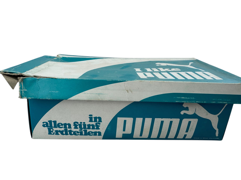 A vintage Puma shoebox in teal and white, featuring the Puma leaping cat logo and the German slogan 'in allen fünf Erdteilen'.
