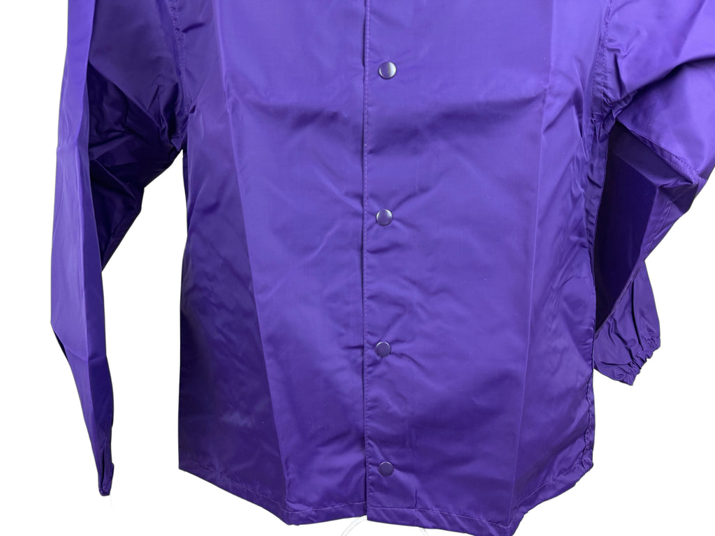 A close-up of a purple snap-front  nylon jacket with long sleeves, shown against a plain white background.