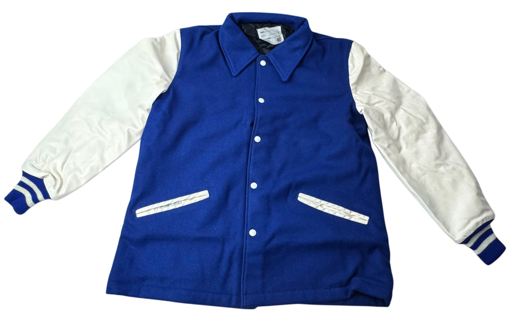 A classic varsity jacket with a royal blue body and white sleeves, featuring a snap-button front, pointed collar, and striped cuffs.