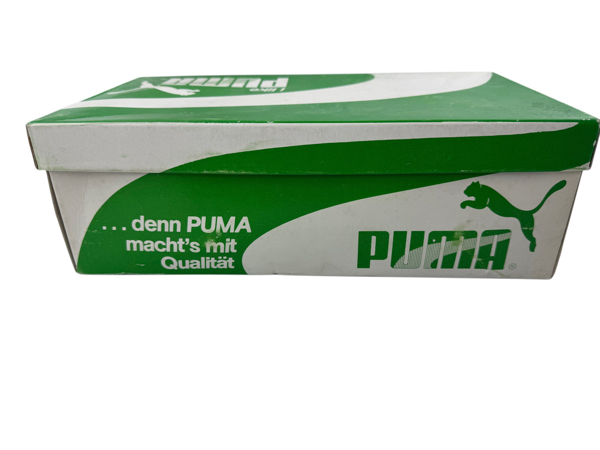 A Puma shoebox in green and white, featuring the Puma logo and German slogan '.