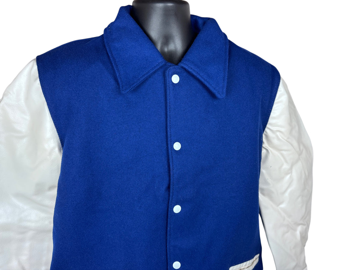 A blue and white varsity-style jacket displayed on a black mannequin torso against a plain white background.