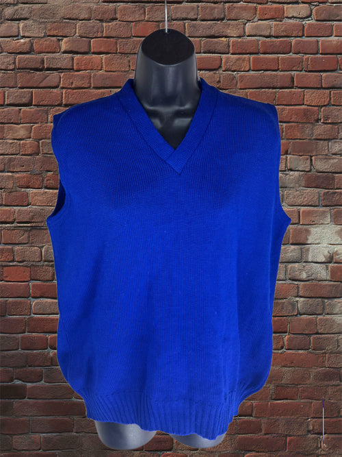 A bright royal blue ribbed knit sweater vest displayed on a black mannequin torso, set against a red-brown brick wall background.