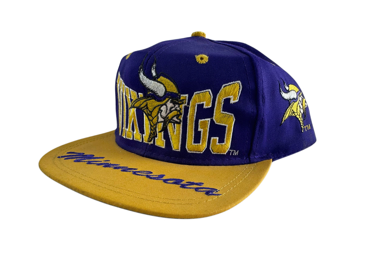 A purple and gold Minnesota Vikings snapback cap featuring embroidered lettering and the team logo on the front and brim, set against a plain white background.