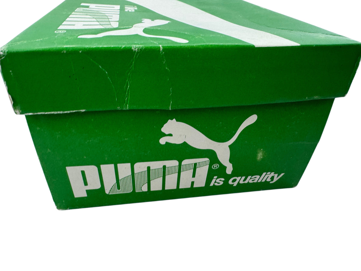 A green Puma shoebox with the white Puma logo and 'is quality' text on the front, photographed against a white background.