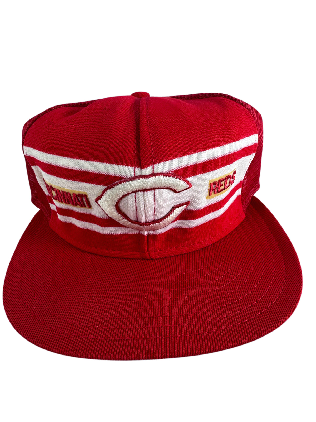 A red and white baseball cap featuring the Cincinnati Reds logo on the front panel, with a structured flat brim and embroidered details.