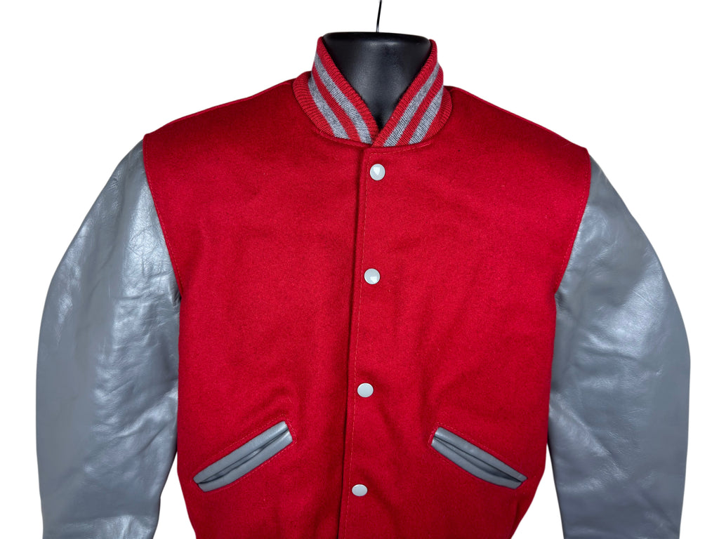 A red and gray varsity jacket displayed on a black mannequin torso against a white background.